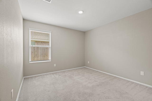 unfurnished room featuring baseboards and carpet flooring