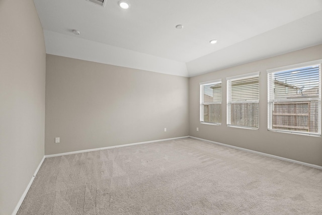 unfurnished room featuring light carpet, visible vents, baseboards, lofted ceiling, and recessed lighting