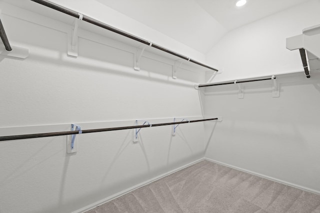 spacious closet with light carpet and lofted ceiling