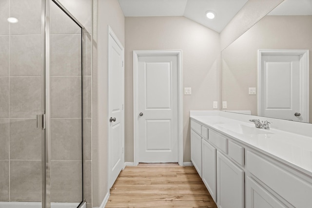 full bath with a stall shower, wood finished floors, and vanity