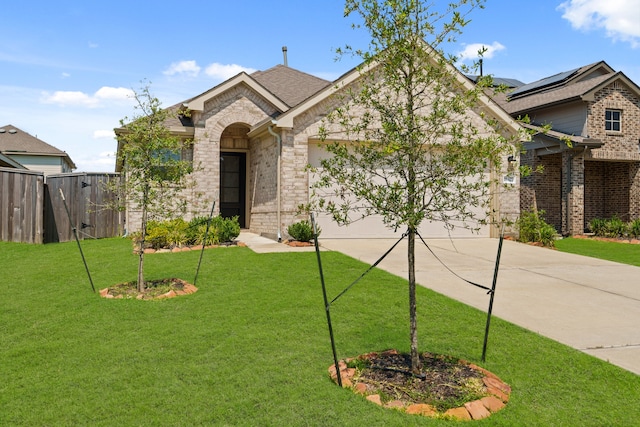 view of front of home with a front yard and solar panels