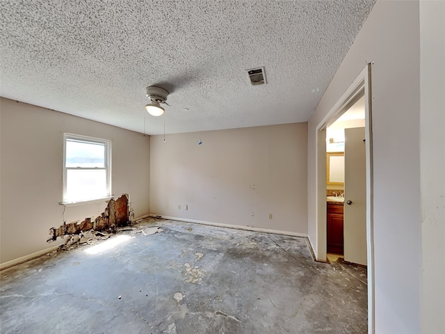 2613 34th Ave N, Texas City, TX 77590 - spare room featuring ceiling fan, a textured ceiling, a sink, baseboards, and concrete flooring