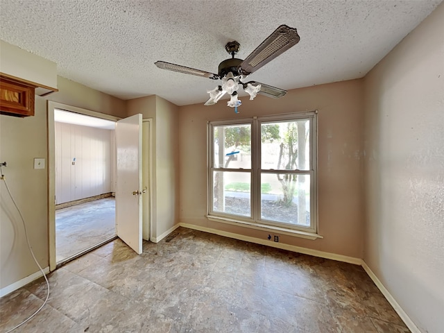 2613 34th Ave N, Texas City, TX 77590 - empty room with baseboards, a textured ceiling, and a ceiling fan