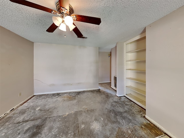 interior space featuring ceiling fan, a textured ceiling, and concrete floors