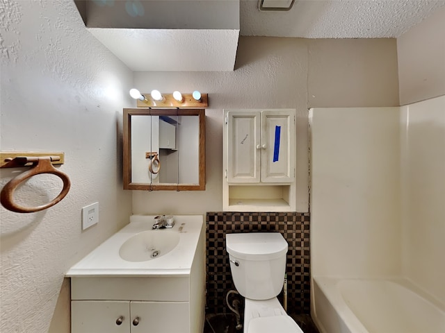 bathroom featuring vanity, a textured ceiling, and toilet