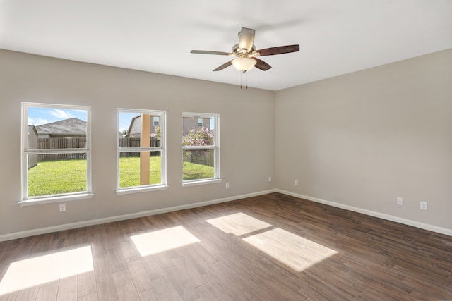 spare room with hardwood / wood-style flooring and ceiling fan