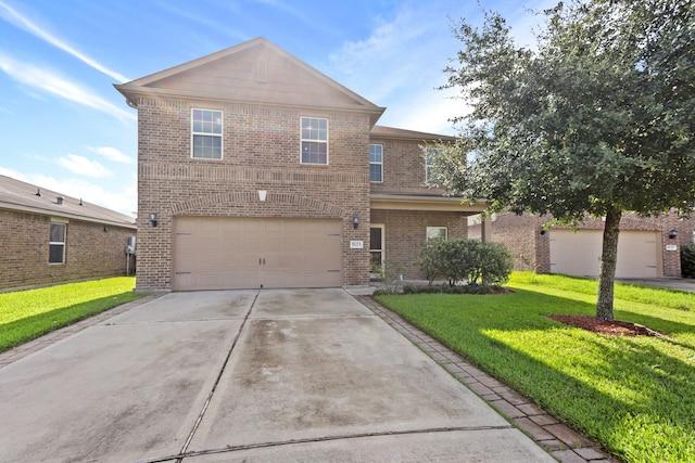 view of property featuring a garage and a front lawn