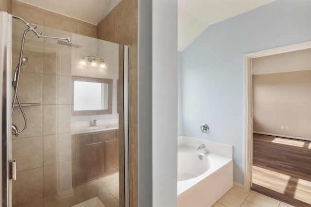 bathroom featuring vaulted ceiling, shower with separate bathtub, sink, and hardwood / wood-style floors