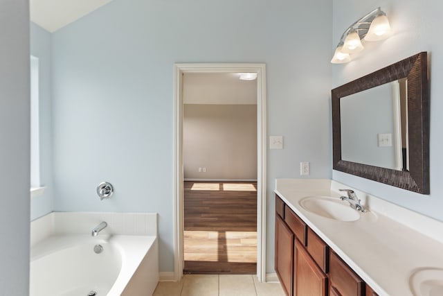 bathroom with a tub, wood-type flooring, and dual bowl vanity