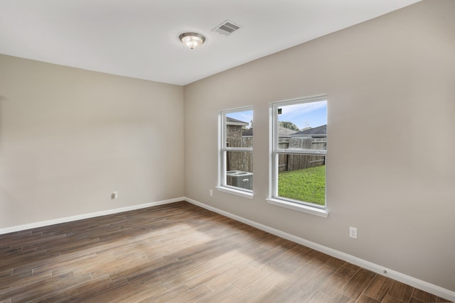 spare room featuring hardwood / wood-style flooring and a wealth of natural light