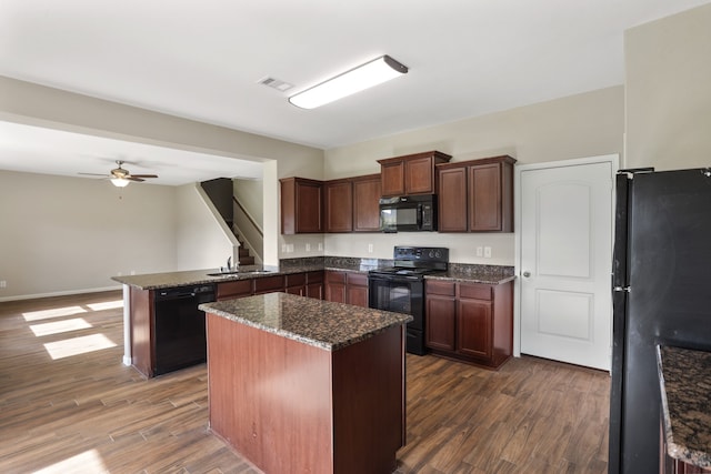 kitchen featuring black appliances, ceiling fan, dark hardwood / wood-style floors, and a center island