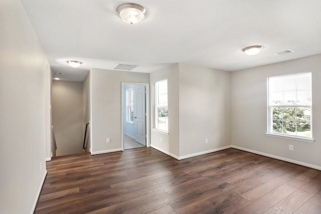 empty room with wood-type flooring and a wealth of natural light