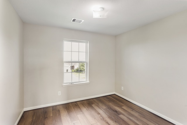 spare room featuring wood-type flooring