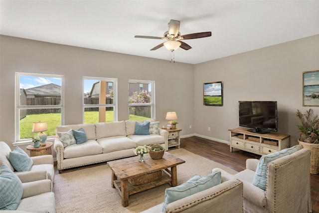 living room featuring dark hardwood / wood-style floors and ceiling fan