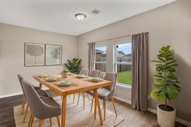 dining space featuring hardwood / wood-style flooring and a healthy amount of sunlight