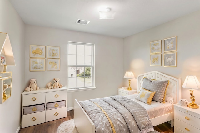 bedroom with dark hardwood / wood-style flooring