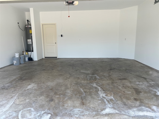 garage featuring electric water heater and a garage door opener