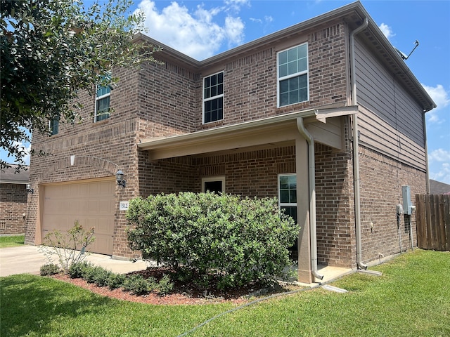 view of front of property with a garage and a front lawn