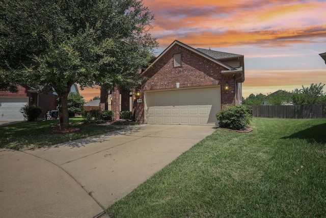 view of front of home with a garage and a yard