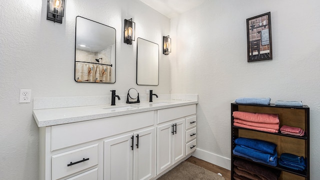 bathroom with vanity and hardwood / wood-style floors