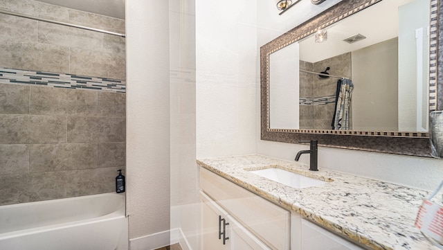 bathroom with vanity and shower / tub combo