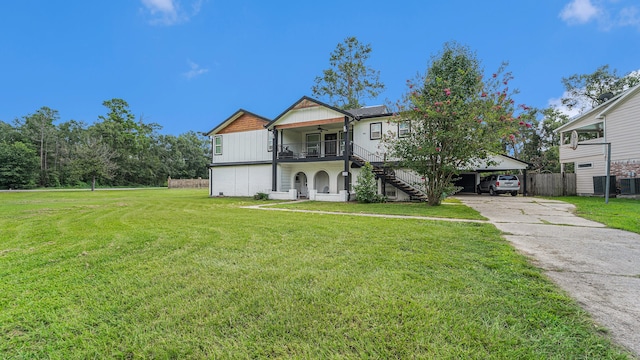 view of front of home with a carport, a porch, and a front lawn