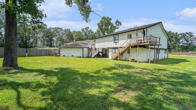 back of house with a deck and a yard