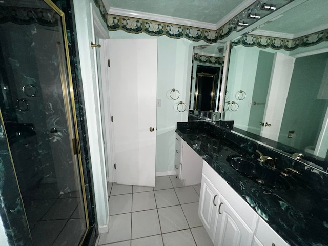 bathroom with an enclosed shower, vanity, crown molding, and tile patterned flooring