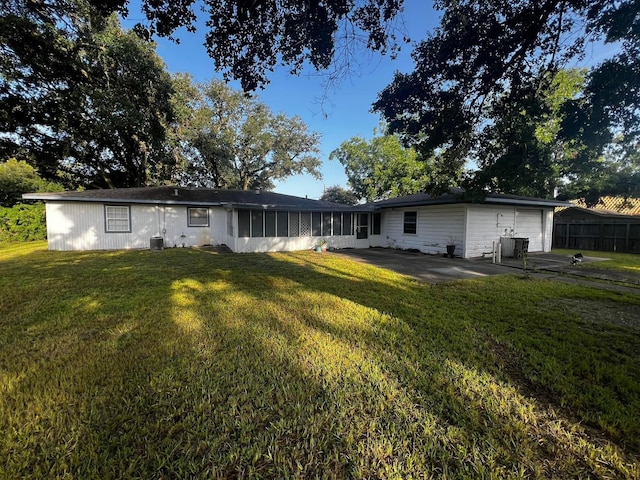 back of house featuring a patio area, fence, and a lawn