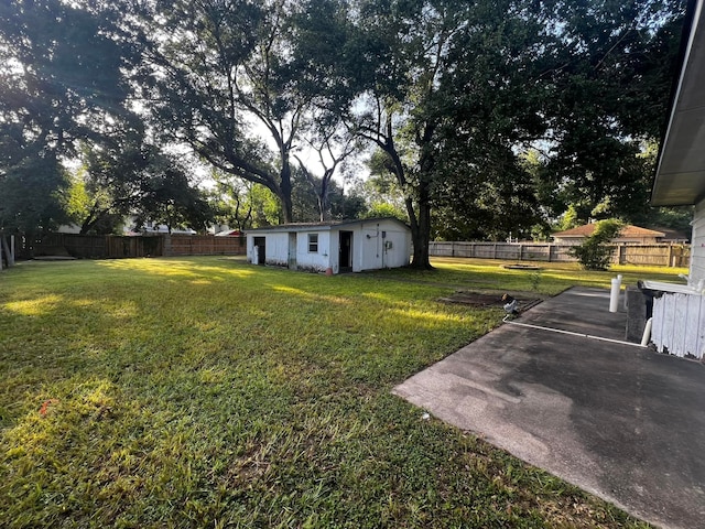 view of yard with a patio area and an outbuilding