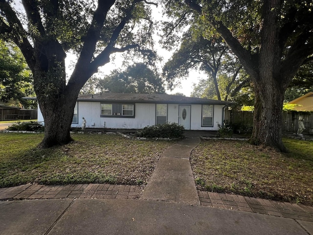 ranch-style house with fence and a front yard