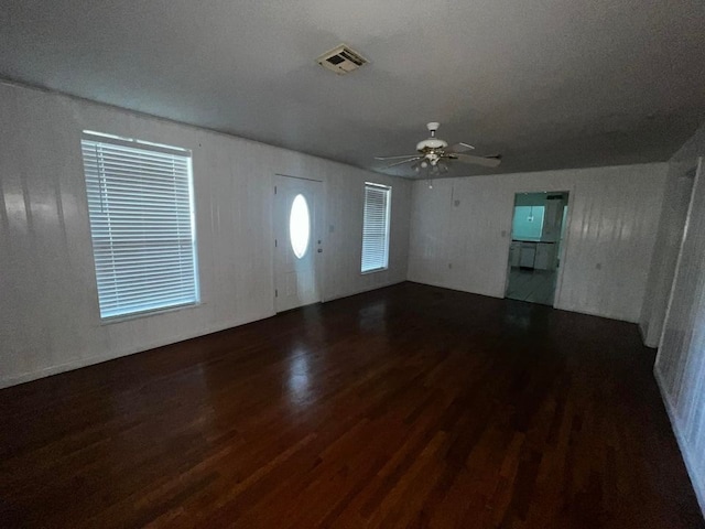 unfurnished living room with hardwood / wood-style flooring and ceiling fan