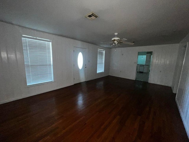 interior space featuring dark wood-style flooring, visible vents, and a ceiling fan