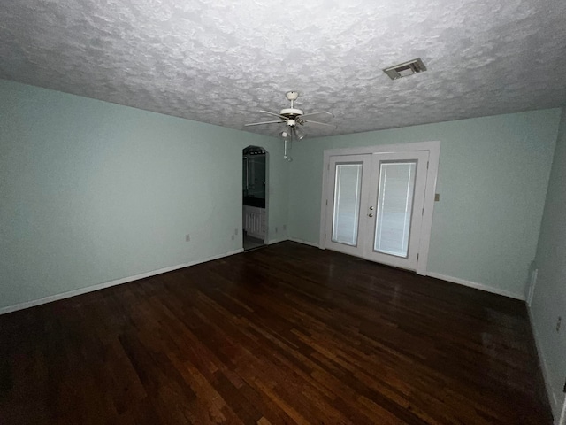 spare room featuring a textured ceiling, ceiling fan, and hardwood / wood-style floors