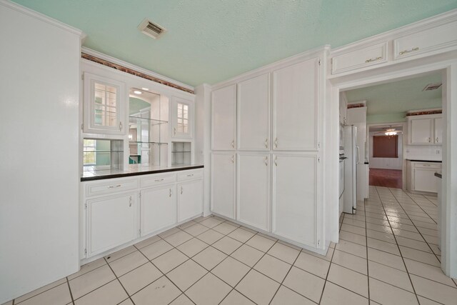 1826 E Ave, Katy, TX 77493 - kitchen with light tile patterned floors, white cabinets, and dark countertops