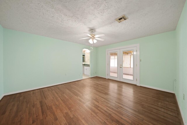 1826 E Ave, Katy, TX 77493 - empty room featuring french doors, wood finished floors, baseboards, a ceiling fan, and a textured ceiling