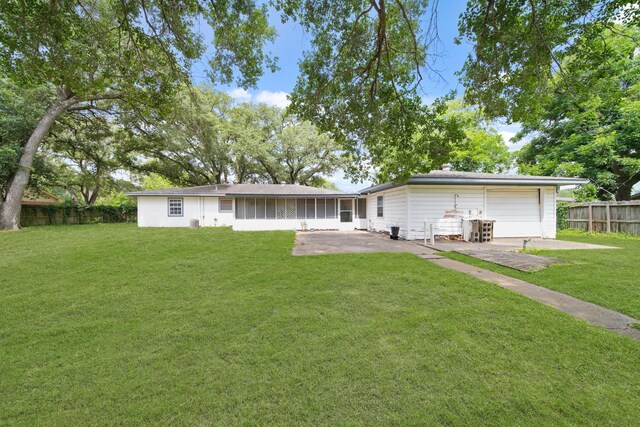1826 E Ave, Katy, TX 77493 - rear view of property with a patio area, a detached garage, and a sunroom