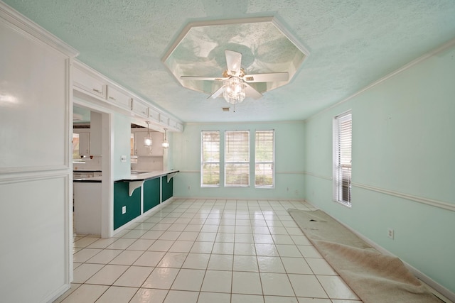 1826 E Ave, Katy, TX 77493 - kitchen featuring a ceiling fan, a textured ceiling, light tile patterned floors, open floor plan, and white cabinetry