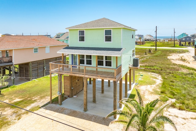 exterior space featuring a carport, a lawn, and cooling unit