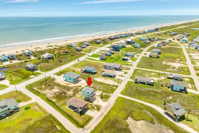 drone / aerial view featuring a view of the beach and a water view