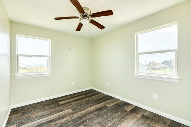 unfurnished room with dark hardwood / wood-style flooring and ceiling fan