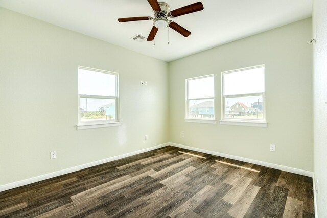 empty room featuring dark wood-type flooring and ceiling fan