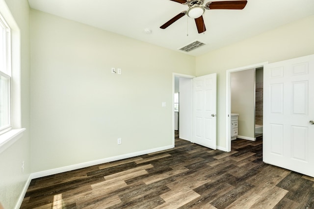 unfurnished bedroom with multiple windows, dark wood-type flooring, and ceiling fan