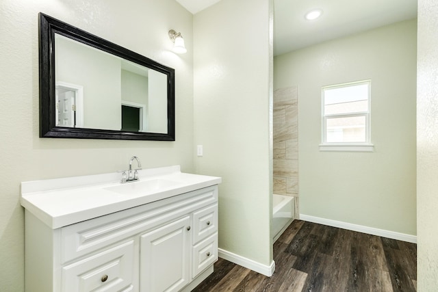 bathroom featuring vanity, tub / shower combination, and wood-type flooring