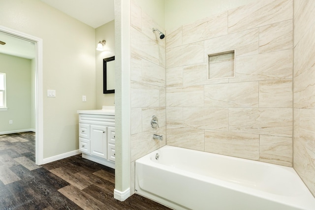 bathroom featuring vanity, tiled shower / bath combo, and hardwood / wood-style floors