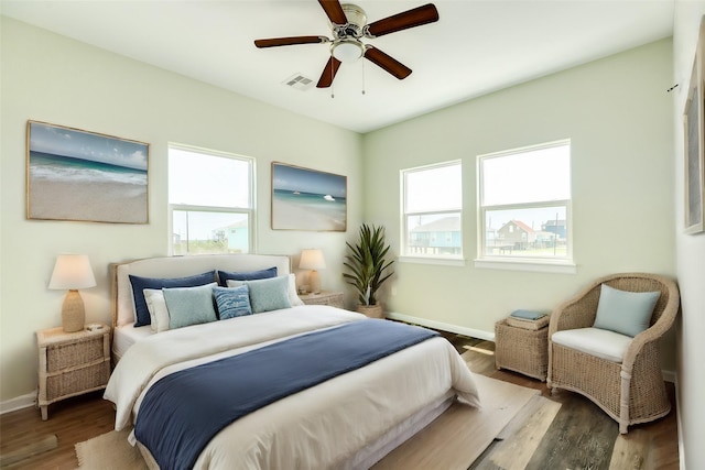 bedroom with ceiling fan and dark hardwood / wood-style floors