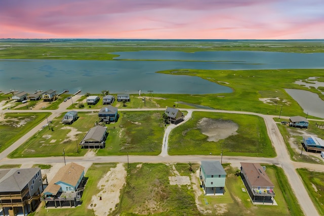 aerial view at dusk with a water view