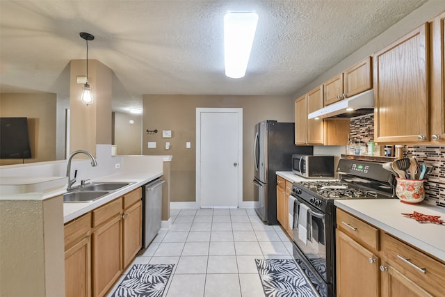 kitchen with appliances with stainless steel finishes, light tile patterned floors, decorative light fixtures, backsplash, and sink