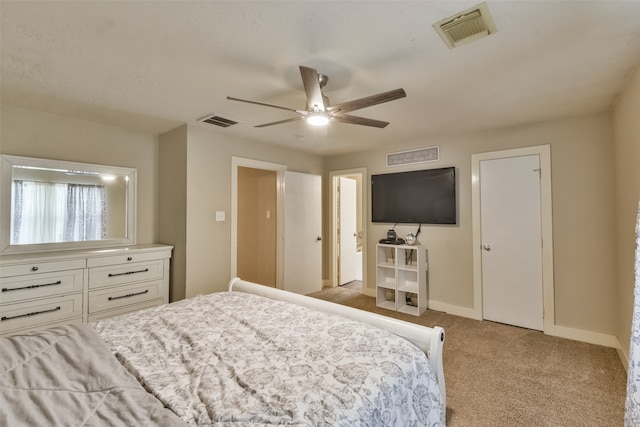 bedroom with ceiling fan and light carpet