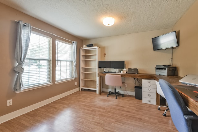 office featuring light hardwood / wood-style flooring and a textured ceiling